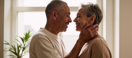 A sunlit window frames an embrace between two middleaged African American individuals photo