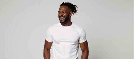 A muscular African American man sporting dreadlocks offers a warm smile photo