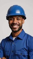 A smiling African American security guard wears a blue uniform and helmet photo