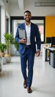 Cheerful African American male manager walking confidently through a colorful office space with tablet emanating positive energy photo