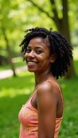 A joyful AfricanAmerican woman with natural hair smiles in a serene nature setting photo