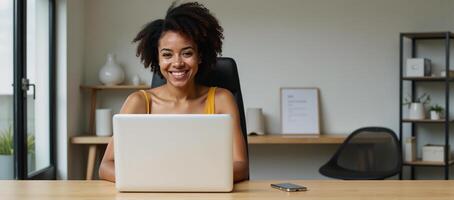 A modern office setting features an AfricanAmerican entrepreneur working on her eCommerce venture photo