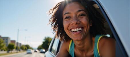 A joyous Black woman enjoys sunlight from her moving car window photo