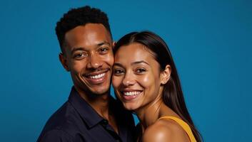 Portrait of joyful interracial pair gazes into the lens against a tranquil blue backdrop photo