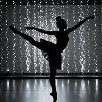 AfricanAmerican ballerina depicted as an elegant silhouette against a backdrop of glittering stage lights photo