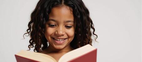 A youthful Black girl smiling and curlyhaired holds a book photo