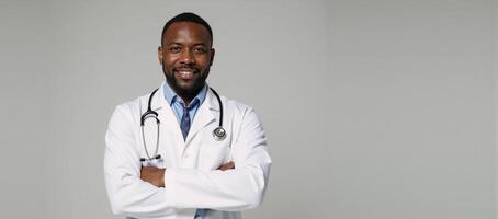 Portrait of an African American doctor proudly displaying stethoscope and uniform photo