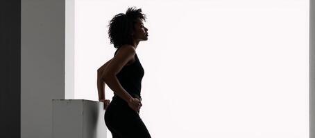 Black silhouette of an AfricanAmerican woman with curls on a white background casual attire profile view photo