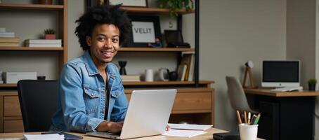 A talented young African American coder at his desk in a highschool setting photo
