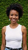 Portrait of a happy middleaged African American woman with quirky expressions against green background photo