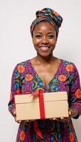 Smiling AfricanAmerican woman Coco with gift box and red tag featured in the People Series against a white backdrop photo