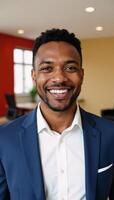 A selfassured young black man grins amidst a vibrant contemporary office setting photo