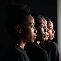 A silhouetted profile portrait showcases Black African and African American faces emphasizing racial equity and challenging racismdiscrimination photo