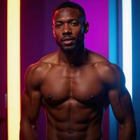 Black male portrait in neonlit studio with an emotive expression African American model photo