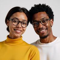 Young AfricanAmerican couple with glasses posed against plain white backdrop photo