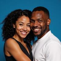 Portrait of joyful interracial pair gazes into the lens against a tranquil blue backdrop photo