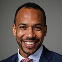 A smiling middleaged African American man is depicted photo