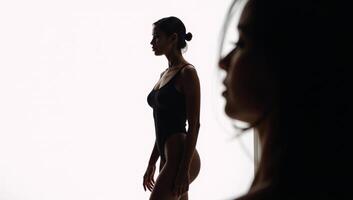 AfricanAmerican woman portrayed as a stylized silhouette on a white studio backdrop photo