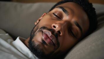 Closeup portrait of peaceful mindful man African American asleep on cozy couch photo