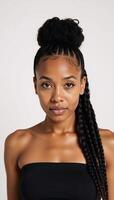 Portrait of a stunning Black African American woman featuring curly braids and bun against a white backdrop showcasing her defined features and direct gaze photo