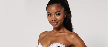 Portrait of an AfricanAmerican woman in seductive maid attire set against a pure white backdrop with ample copy space photo