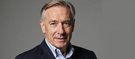 Senior gay man depicted against a simple gray backdrop in a portrait style image photo