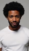 African American Man with Afro Hair stands alone against an empty backdrop photo