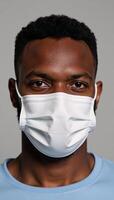 An AfricanAmerican man wearing a face mask due to COVID photo