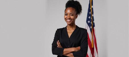 A youthful AfricanAmerican stands boldly before an American flag exuding pride and confidence photo