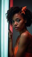 Abstract backdrop features a vibrant African American woman portrait with curls and orange accents illuminated by neon lights Design header photo