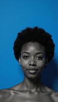 An African American woman with an Afro is depicted against a blue backdrop photo