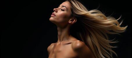 A stunning black woman with long blonde hair captured in motion against a black background photo
