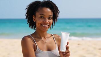 A black AfricanAmerican woman stands on a beach holding a SPF protective sunscreen for her bodys skin care photo