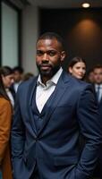 Intense corporate meeting featuring a determined focused African American man in business attire amidst a busy office backdrop photo