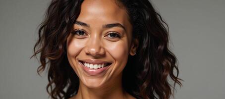 A radiant African American woman with curls showcases gleaming skin and a joyful smile photo