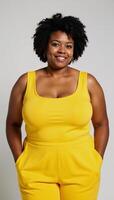 A stylish plussize woman with an afro flaunts trendy jumpsuit in art photo