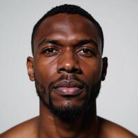 A handsome AfricanAmerican male exhibiting complex feelings illuminated by vibrant abstract lighting photo