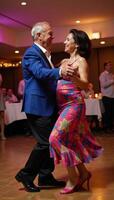 Senior AfricanAmerican couple enjoying a fun night out while dancing Salsa together at a social gathering photo