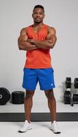 Confident Black man poses at gym in activewear AfricanAmerican Male Portrait photo