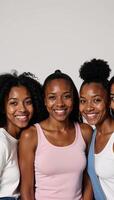 Five smiling black women with diverse hairdos pose for the camera photo