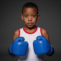 AfricanAmerican boy donning boxing gloves and displaying combat readiness photo