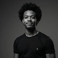 An African American man with an Afro stands against an isolated background photo