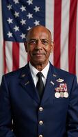 An elderly AfricanAmerican veteran stands proudly before an American flag in his military uniform adorned with medals for Veterans Day photo