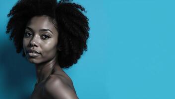 African American woman with an Afro against a blue backdrop photo