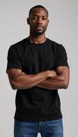 African American male model poses in a blank black tee perfect for logodesign placement on a neutral backdrop photo