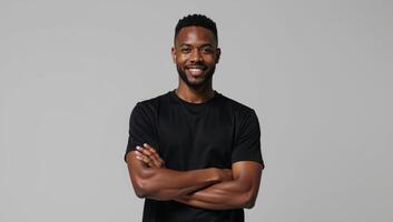 African American male model poses in a blank black tee perfect for logodesign placement on a neutral backdrop photo