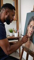 AfricanAmerican male artist creating a portrait using oil paints on a canvas photo