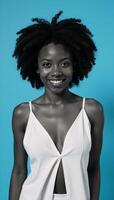 African American woman with an Afro against a blue backdrop photo