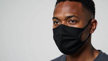 An AfricanAmerican man wearing a face mask due to COVID photo