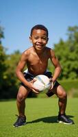 Dynamic portrait of an energetic and confident AfricanAmerican boy holding a rugby ball ready to play photo